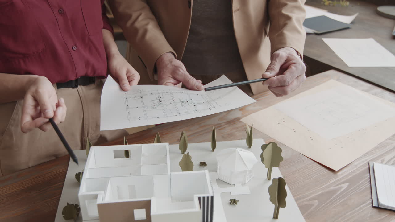 Architects With Blueprints And 3D House Layout