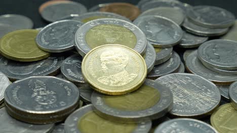 a group of thai coins piled up and rotating