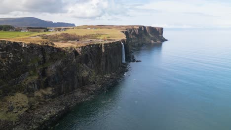 Wide-drone-panning-shot-of-the-Scottisch-landscape-with-the-high-mealt-falls-on-a-sunny-day