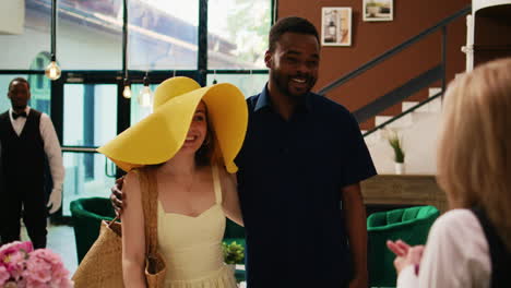 Couple-of-tourists-at-front-desk