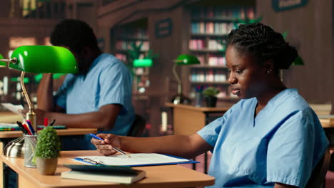 african american med school pupil studies pharmacology notes in a library