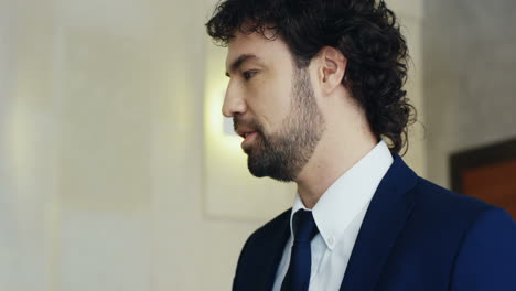 close-up view of caucasian businessman speaker on a podium wearing formal clothes and talking in a conference room