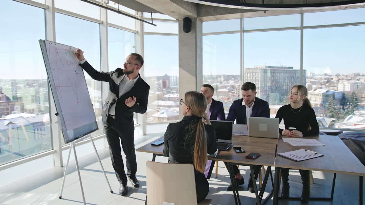 Teamwork in the meeting room. Developing strategies and new ideas using chart. Team of professionals in the light office.