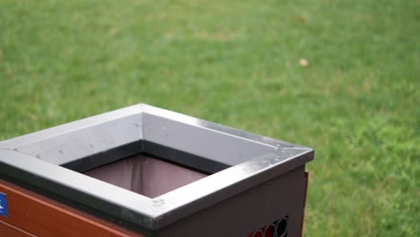 close-up of a metal trash can in a park