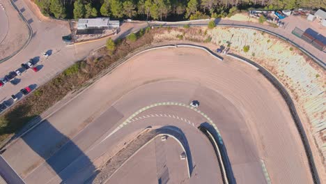 White-car-races-through-sharp-curve-at-Circuit-Parcmotor-Castelloli,-Barcelona