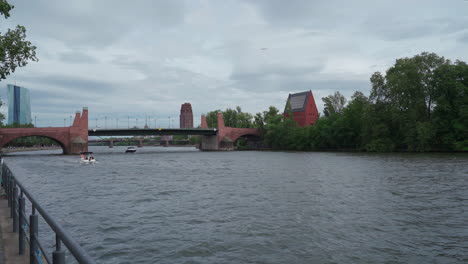 Boats-sail-under-a-bridge-on-a-cloudy-day