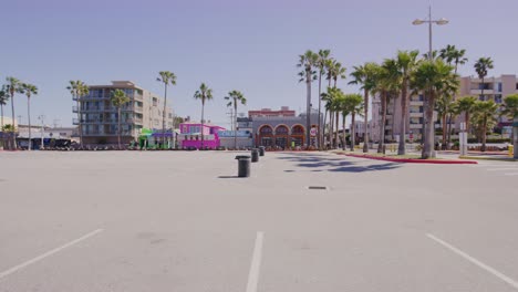 empty boardwalk and closed bicycle rental shop at venice beach during the covid19 pandemic in los angeles, california