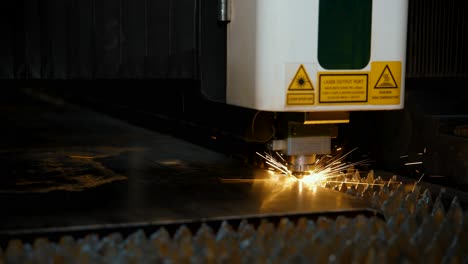 automatic laser cutting of a metal sheet into parts. close-up of a cnc machine at an industrial plant