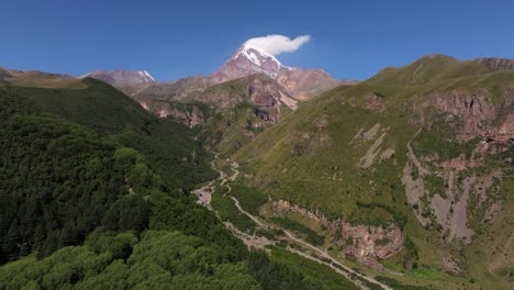 sliding shot above caucasus mountain range, mount kazbek, georgia