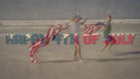 digital composite video of happy 4th of july text against kids running with u.s. flag on the beach