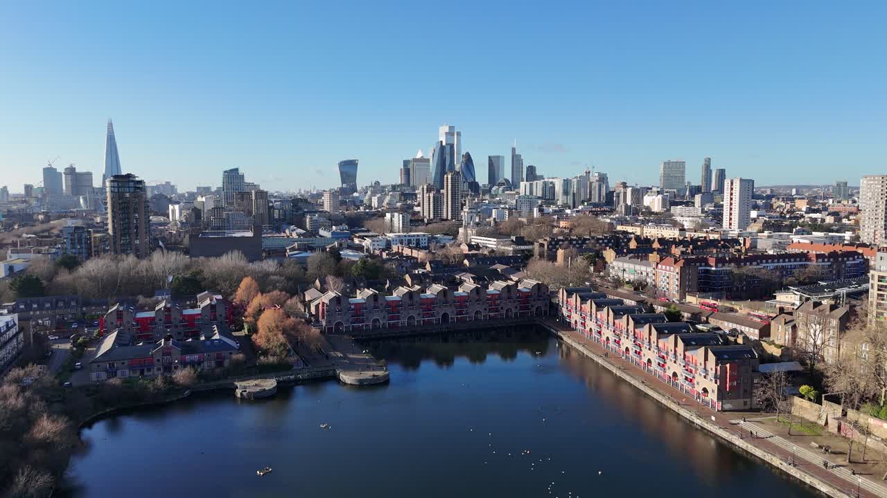 Shadwell Basin East London UK pull back drone aerial reverse reveal city skyline