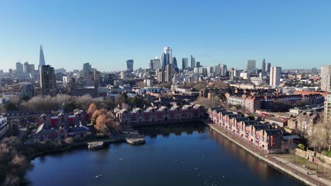 shadwell basin east london uk pull back drone aerial reverse reveal city skyline