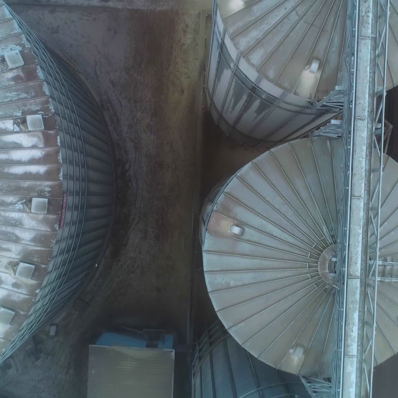 Huge elevator construction flight over. Big silo tanks with grain elevator