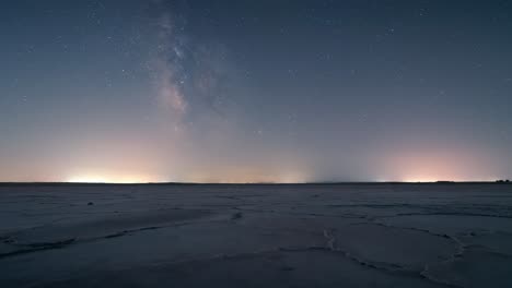 night timelapse of the milky way and moonset above a salt flat in castilla-la mancha, spain, with starry sky and serene desert-like scenery