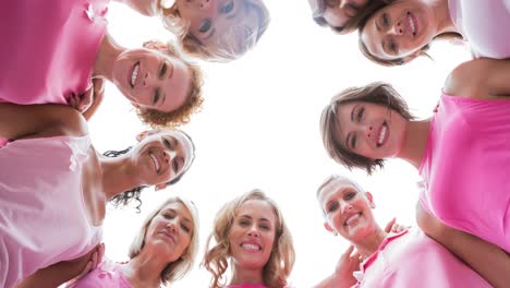 Portrait-of-diverse-group-of-smiling-women-outdoors-in-the-sun-from-below