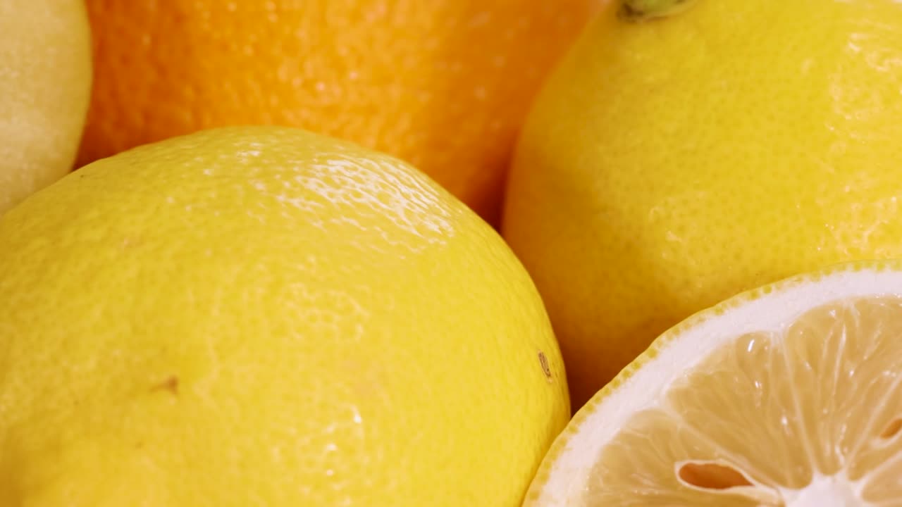 A colorful arrangement showcasing fresh lemons, kiwis, mangoes, papayas, bananas, pomegranates, strawberries, and apples.