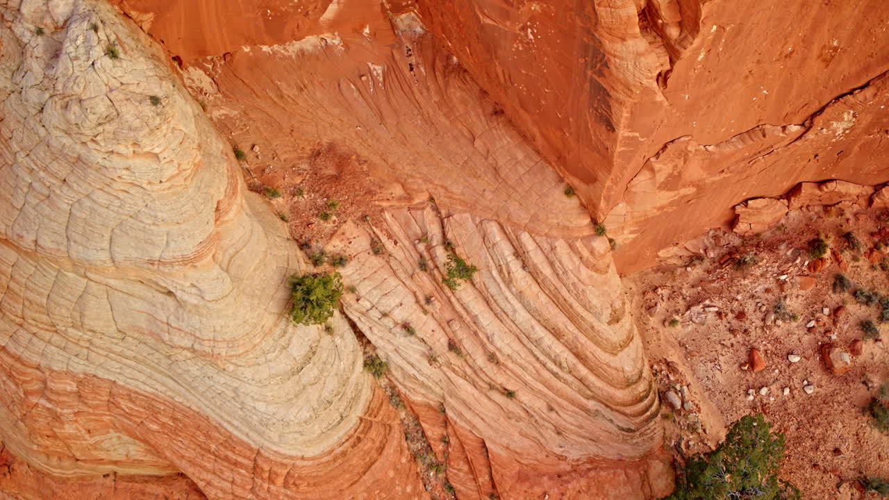 High-flying drone reveals mesmerizing rock patterns carved into red canyon stone.