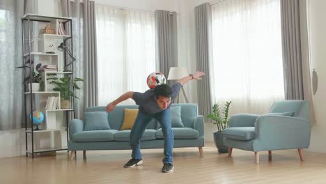 asian man show skill with soccer ball in living room, soccer freestyle