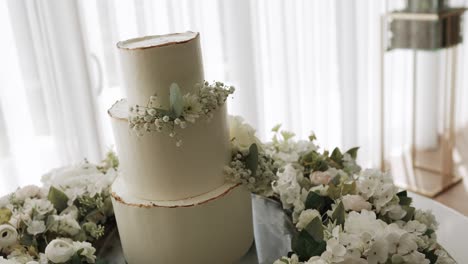 three tier white wedding cake with baby breath and floral table decoration