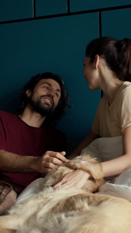 couple and dog in bed