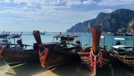 long tail boats at phi phi don harbor - nearest place for daily trip to maya bay and other islands