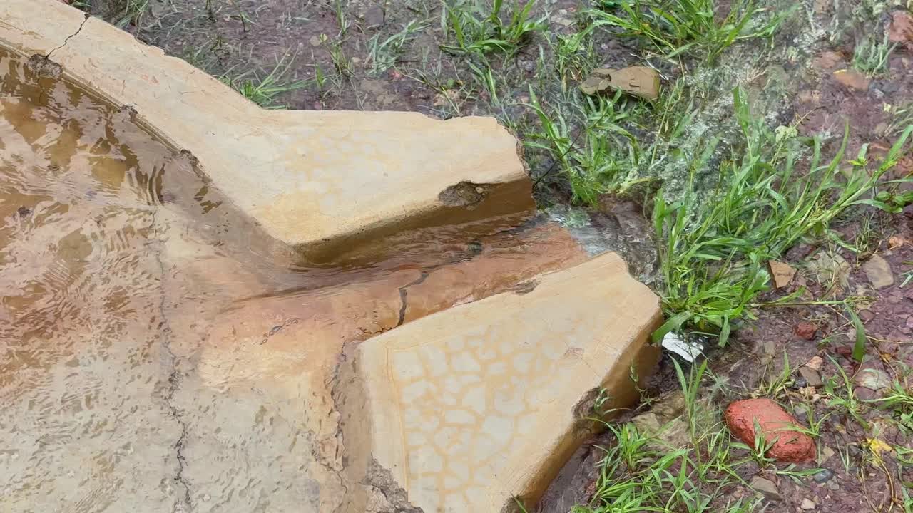 Closeup of a water stream coming from a gushing borewell with a strong ground water source