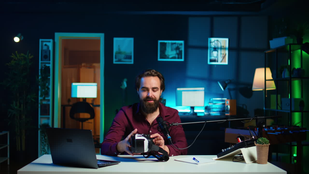 Tech vlogger reviewing VR goggles in neon lit studio