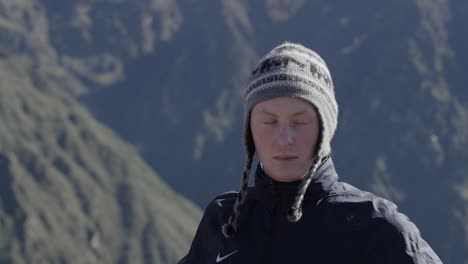 Medium-close-up-of-caucasian-male-with-traditional-Peruvian-hat-on-smiling-and-enjoys-the-view-over-Colca-Canyon-in-Peru