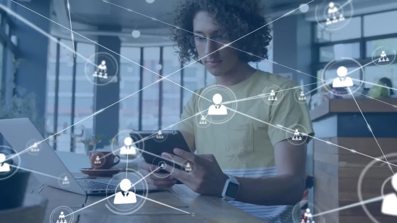 Animation of network of profile icons against biracial man using digital tablet at a cafe