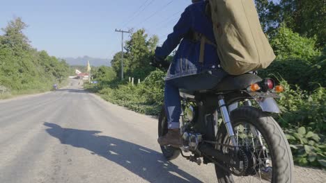 driver riding motorcycle on the country road, video in 4k