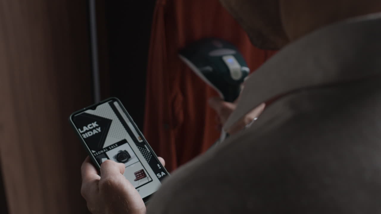 Person using a smartphone and a steamer to shop online