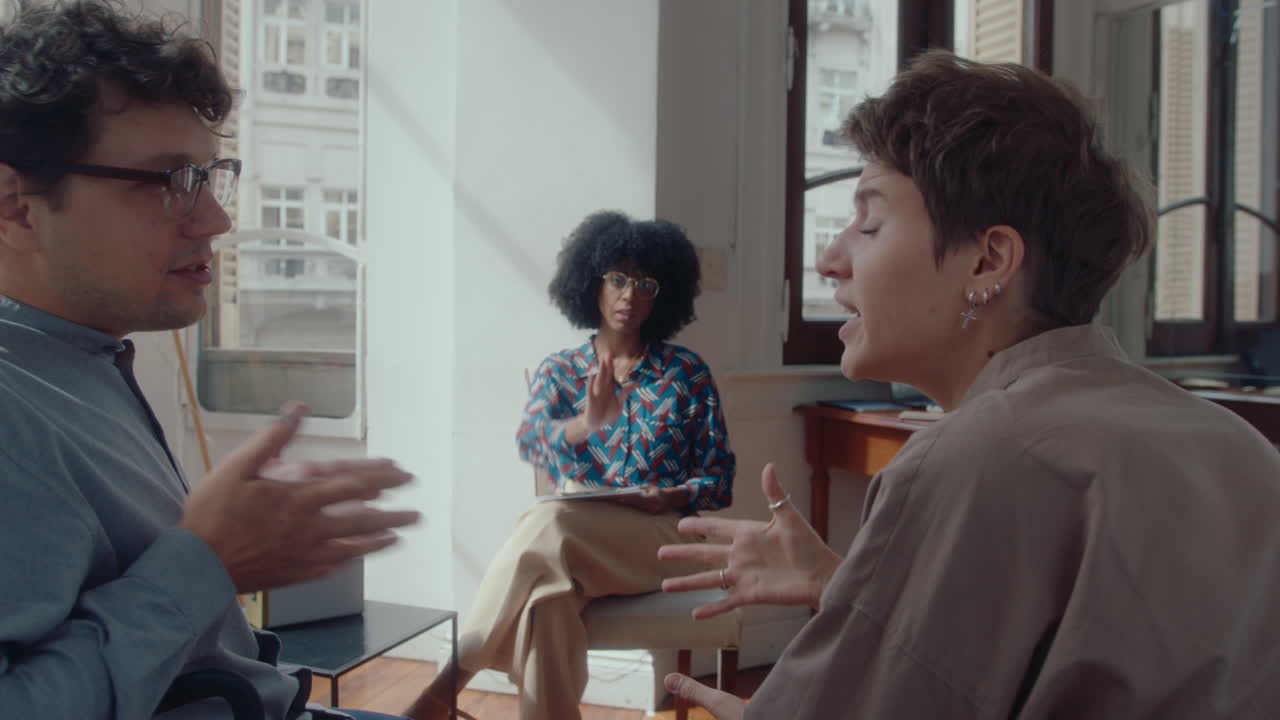 Couple Quarrelling and Therapist Calming Them Down on Consultation