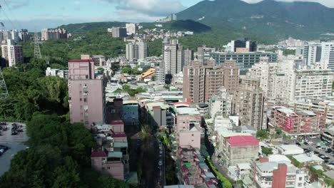 aerial view of guandu hospital and surrounding taipei cityscape and mountains