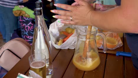 lady mixing a traditional and typical portuguese alcoholic drink called poncha in slowmotion