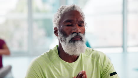 senior man meditating in a fitness class