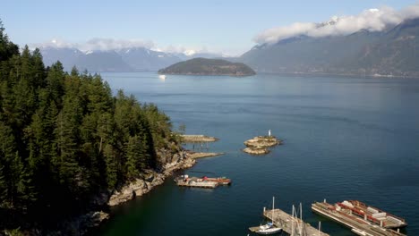 boats dock on the marina in howe sound with bowyer island in the distance from horseshoe bay in bc, canada