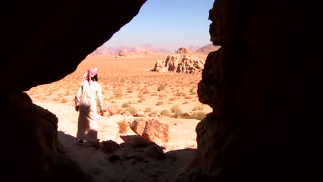 a bedouin man looks out across the desert