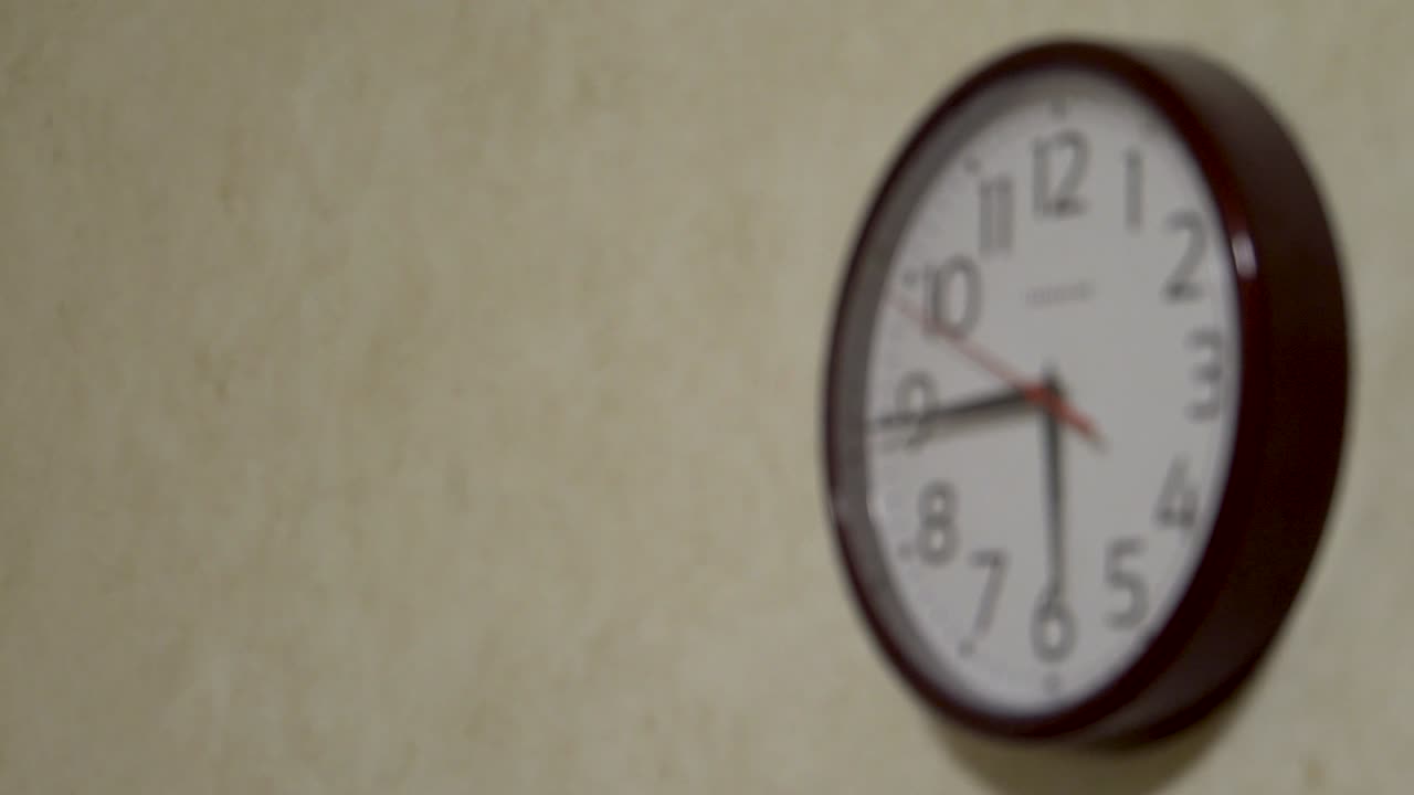Clock with arrows on the wall blurry