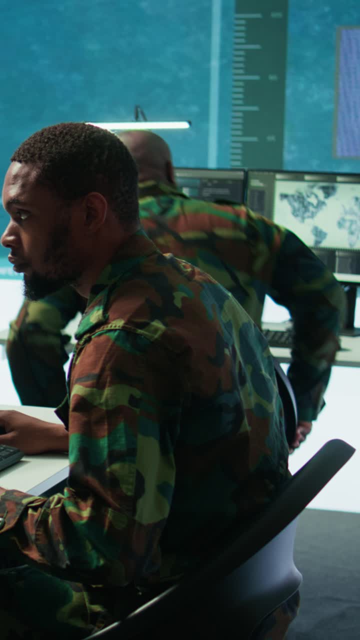 Vertical Video Soldier working with AI intelligence on pc in control room