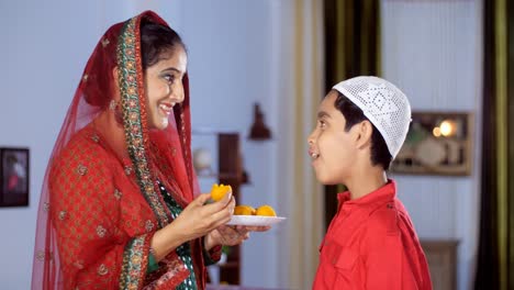 a pretty muslim lady and her adorable son celebrate the festival of eid together - an auspicious occasion, a festive season