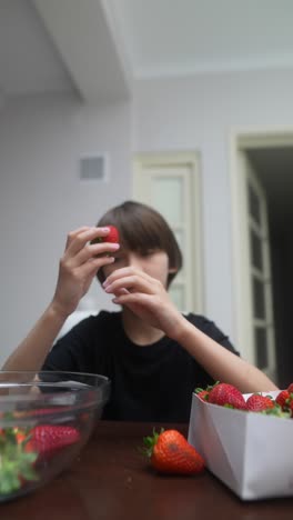 boy picking strawberries at home