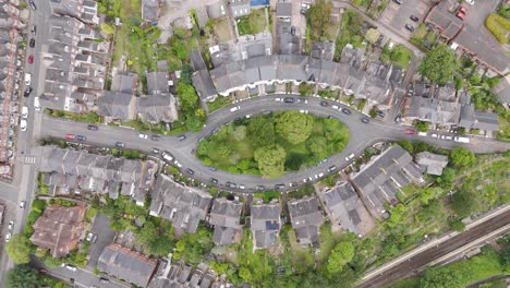 Top-down-aerial-view-of-a-crescent-street-lined-with-charming-houses,-showcasing-unique-urban-design-in-the-UK