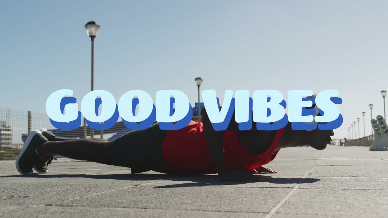 Man starting low and performing push-ups for fitness while GOOD VIBES title partly obscuring torso