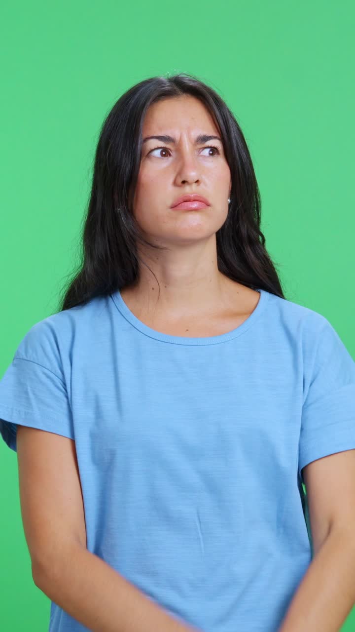Pensive woman thinking about a solution on green screen