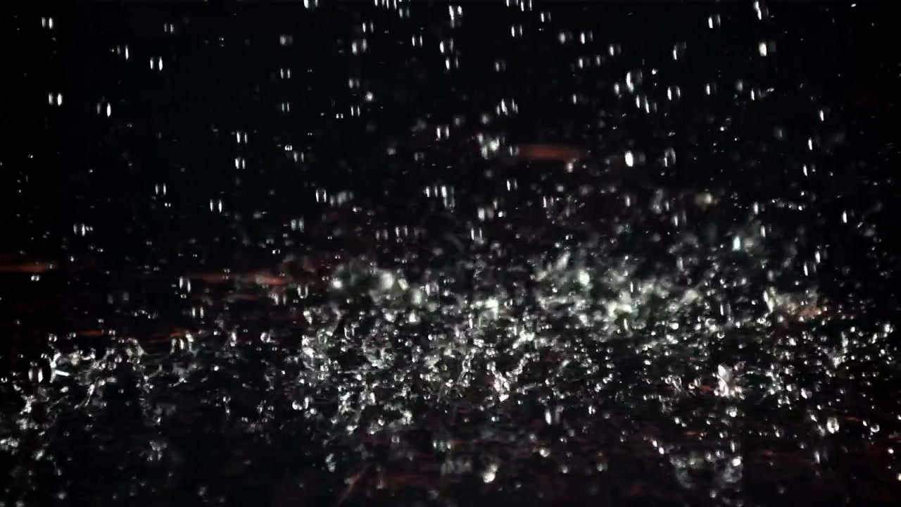 Slow Motion Water Droplets Splashing on a Dark Background