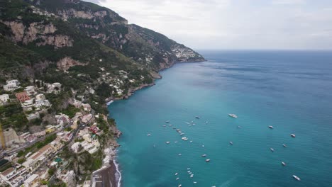 turquoise water in bay at positano, italy, amalfi coast from above