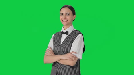 Portrait-of-Happy-Indian-woman-waiter-standing-crossed-hands-Green-screen