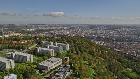 Prague-Czechia-Aerial-v44-drone-flyover-Petrin-hill-capturing-urban-park-and-gardens,-elevation-cityscape-views-of-Mala-Strana-and-Old-Town-across-Vltava-river---Shot-with-Mavic-3-Cine---November-2022