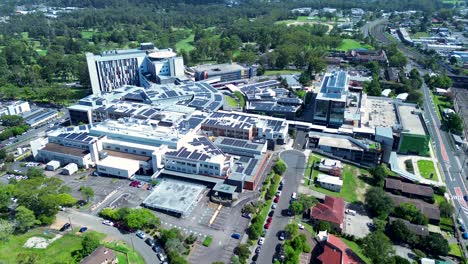 drone aerial gosford hospital healthcare medical surgery services buildings carpark street infrastructure town central coast australia 4k