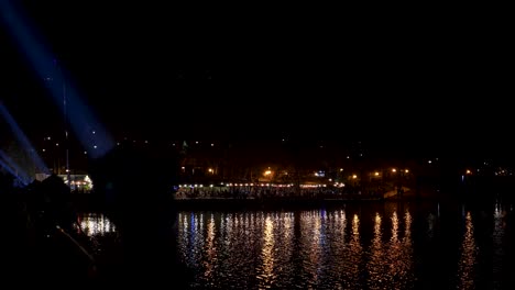 nighttime symphony of light and laser show around city lake: a captivating and enchanting landscape with mesmerizing visuals